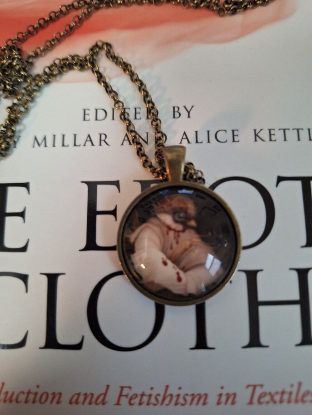 Brass necklace with bird and flower pendant